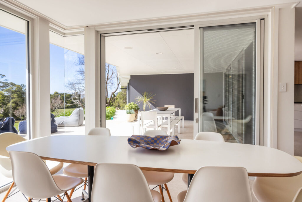 The dining room opens to the patio via double glazed sliding doors by Hanlon Windows Australia.